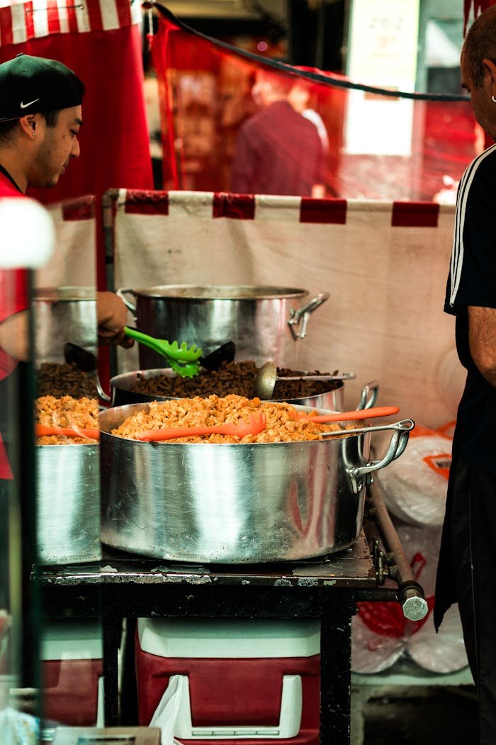 A bustling street food stand in São Paulo, Brazil, offering traditional dishes.